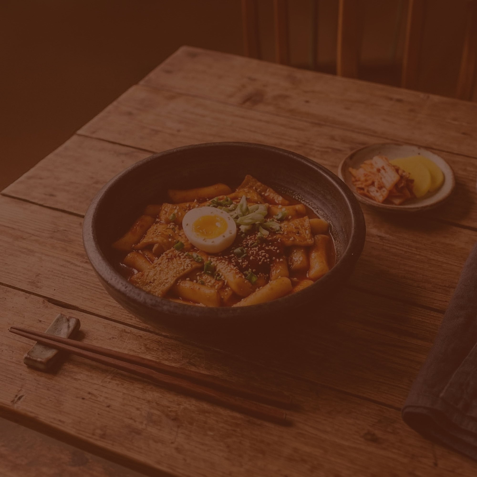 Bowl of ramen with a soft-boiled egg on a wooden table
